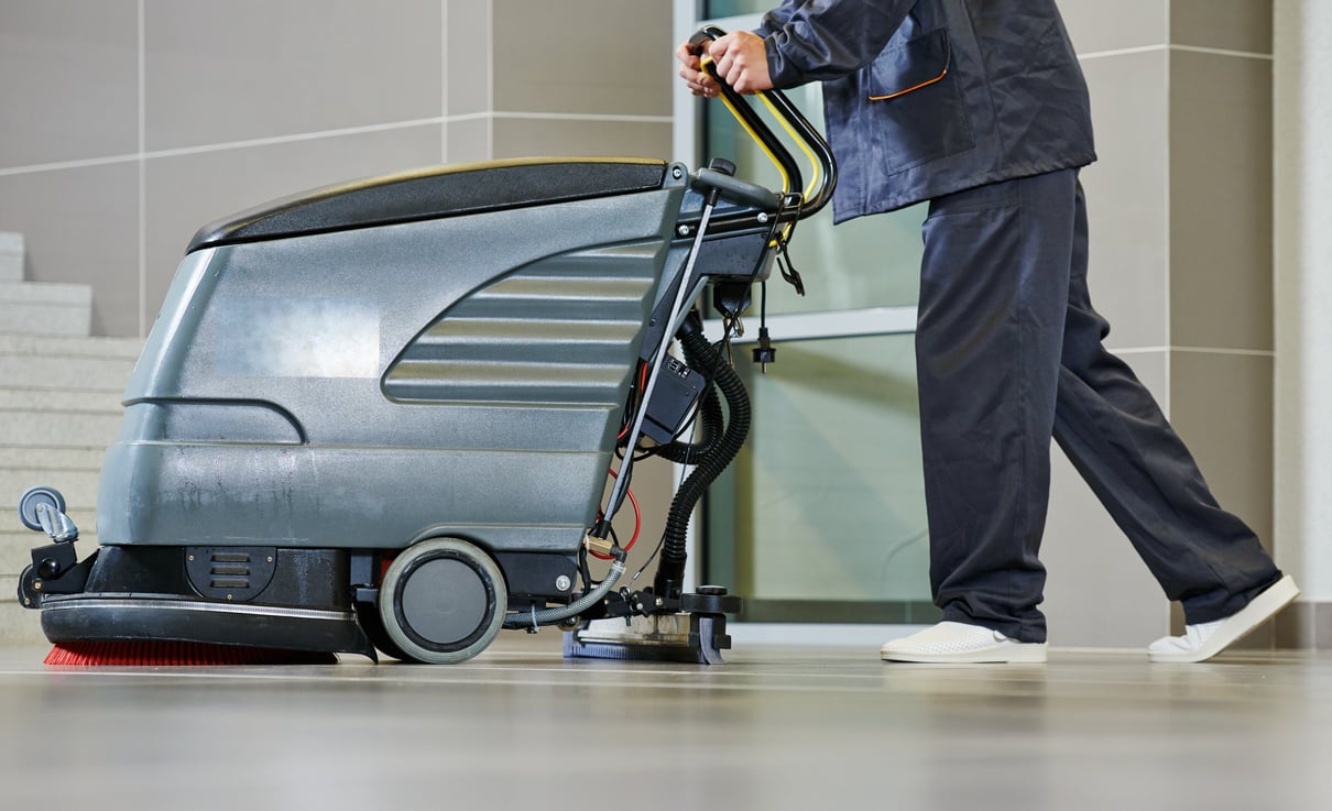 Worker Cleaning Floor with Machine